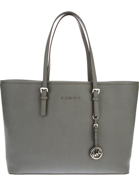 michael kors gray shoulder bag with front pocket|Michael Kors white tote bag.